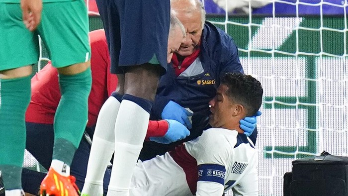Portugal's Cristiano Ronaldo is treated on the pitch during the UEFA Nations League soccer match between the Czech Republic and Portugal at the Sinobo stadium in Prague, Czech Republic, Saturday, Sept. 24, 2022. (AP Photo/Petr David Josek)