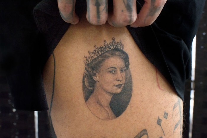LONDON, ENGLAND - SEPTEMBER 22: A micro portrait of Queen Elizabeth II tattooed a few days ago on September 22, 2022 in London, England. The 27-year-old tattoo artist Felix known as Felix Thomas Tattoo had a portrait of the Queen tattooed two days after her death as a tribute and sign of respect for the Queen done by tattoo artist Julian known as Maram Tattoo, in No Regrets Studio in London. Elizabeth Alexandra Mary Windsor was born in Bruton Street, Mayfair, London on 21 April 1926. She married Prince Philip in 1947 and acceded to the throne of the United Kingdom and Commonwealth on 6 February 1952 after the death of her Father, King George VI. Queen Elizabeth II died at Balmoral Castle in Scotland on September 8, 2022, and is succeeded by her eldest son, King Charles III.(Photo by Laura Lezza/Getty Images)