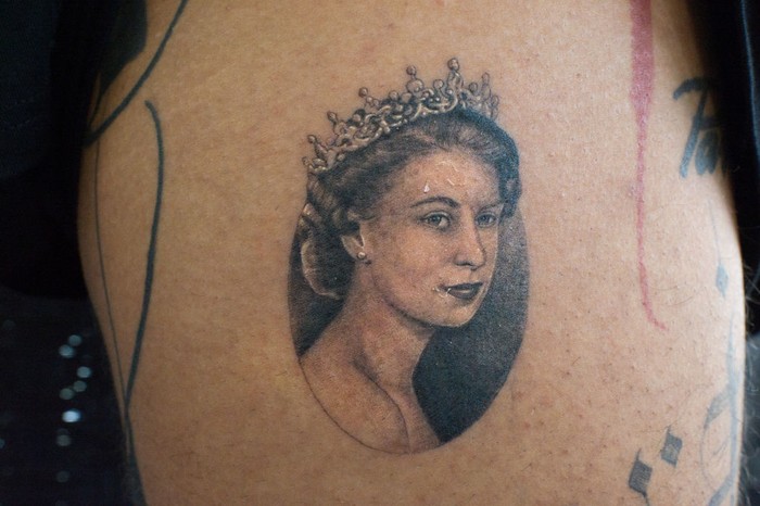 LONDON, ENGLAND - SEPTEMBER 22: A micro portrait of Queen Elizabeth II tattooed a few days ago on September 22, 2022 in London, England. The 27-year-old tattoo artist Felix known as Felix Thomas Tattoo had a portrait of the Queen tattooed two days after her death as a tribute and sign of respect for the Queen done by tattoo artist Julian known as Maram Tattoo, in No Regrets Studio in London. Elizabeth Alexandra Mary Windsor was born in Bruton Street, Mayfair, London on 21 April 1926. She married Prince Philip in 1947 and acceded to the throne of the United Kingdom and Commonwealth on 6 February 1952 after the death of her Father, King George VI. Queen Elizabeth II died at Balmoral Castle in Scotland on September 8, 2022, and is succeeded by her eldest son, King Charles III.(Photo by Laura Lezza/Getty Images)