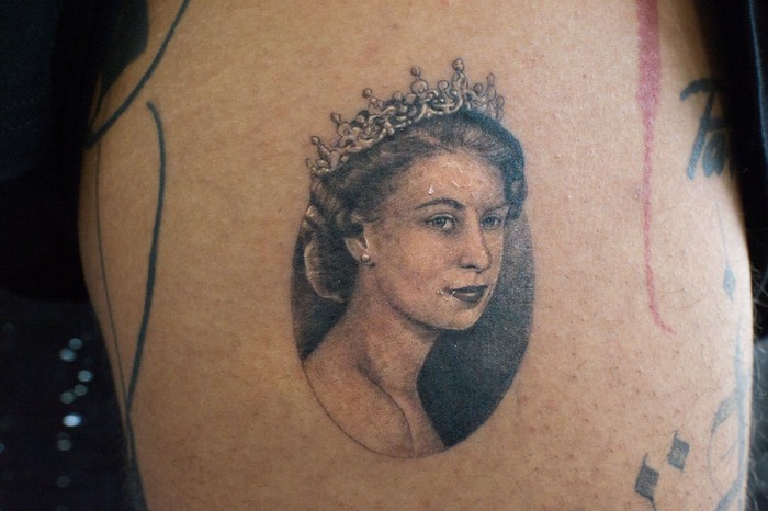 1426788550 LONDON, ENGLAND - SEPTEMBER 22: A micro portrait of Queen Elizabeth II tattooed a few days ago on September 22, 2022 in London, England. The 27-year-old tattoo artist Felix known as Felix Thomas Tattoo had a portrait of the Queen tattooed two days after her death as a tribute and sign of respect for the Queen done by tattoo artist Julian known as Maram Tattoo, in No Regrets Studio in London. Elizabeth Alexandra Mary Windsor was born in Bruton Street, Mayfair, London on 21 April 1926. She married Prince Philip in 1947 and acceded to the throne of the United Kingdom and Commonwealth on 6 February 1952 after the death of her Father, King George VI. Queen Elizabeth II died at Balmoral Castle in Scotland on September 8, 2022, and is succeeded by her eldest son, King Charles III.(Photo by Laura Lezza/Getty Images)