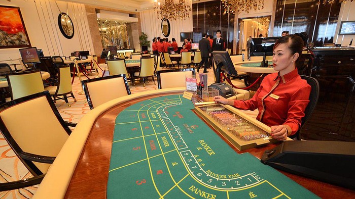 MANILA, PHILIPPINES - MARCH 16:  Casino dealers await the countdown during the grand opening of the Solaire resort and casino on March 16, 2013 in Paranaque City, Philippines. The Solaire group have invested USD $1.2 billion into the high-end casino, and are banking on luring VIP gamblers away from Macau. The sprawling casino resort sits on 60 hectares of reclaimed land in Manila Bay and is the first of four huge casino venues that are set to be built one year after the other. Shares in Solaire have risen 60 per cent in the past six months on anticipation of fast returns on the investment, and numerous other casino groups globally will be watching to see if the investment by Solaire pays off.  (Photo by Dondi Tawatao/Getty Images)
