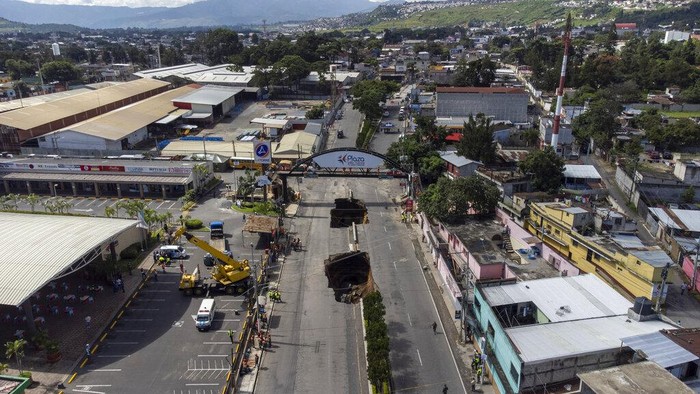 Lubang Raksasa Bermunculan Lagi di Tengah Jalan Guatemala A vehicle is pulled from a sinkhole in Villa Nueva, Guatemala, Sunday, Sept. 25, 2022. Rescuers are searching for people who are believed to have fallen into the sinkhole while driving their vehicle, while four others were rescued alive from the scene on Saturday night. (AP Photo/Moises Castillo)