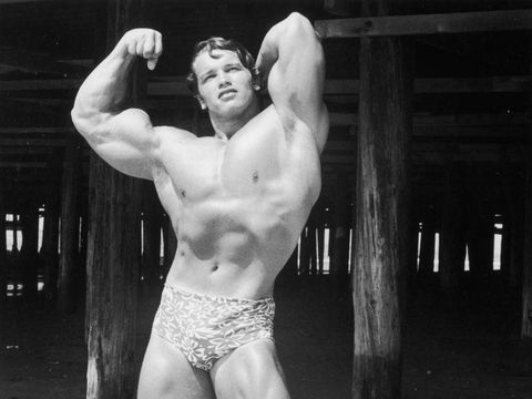 circa 1966:  Full-length image of Austrian-born bodybuilder Arnold Schwarzenegger flexing his muscles and wearing a print bathing suit, Muscle Beach, Santa Monica, California.  (Photo by Hulton Archive/Getty Images)