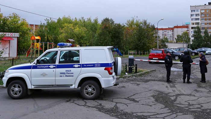 Aksi Ngeri Penembakan di Sekolah Rusia, 13 Orang Tewas A woman talks to police officers securing area after a school shooting in Izhevsk, Russia September 26, 2022. REUTERS/Stringer