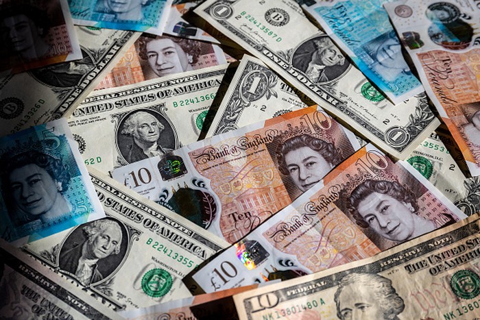 BATH, UNITED KINGDOM - SEPTEMBER 25: In this photo illustration, British GDP £1 coins and bank notes are pictured on September 25, 2022 in Bath, England. The UK pound sterling fell to its lowest level against the U.S. dollar since 1985, as concerns grew at the prospect of a surge in the UK government borrowing to pay for the multiple tax cuts, announced in Conservative Party chancellor Kwasi Kwarteng’s mini-budget. The fall in the value of sterling is also contributing to the UKs cost of living crisis, as inflation hits a near-30-year high. (Photo Illustration by Matt Cardy/Getty Images)
