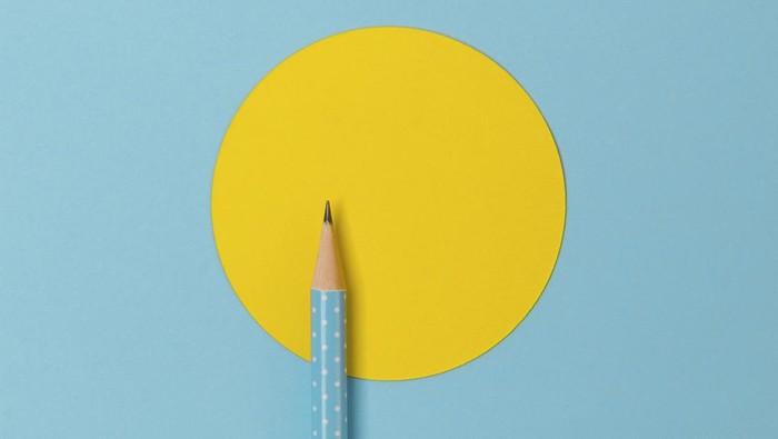 Top view of turquoise polka dot pencil on colorful paper combine with yellow circle. Minimalist template with copy space.