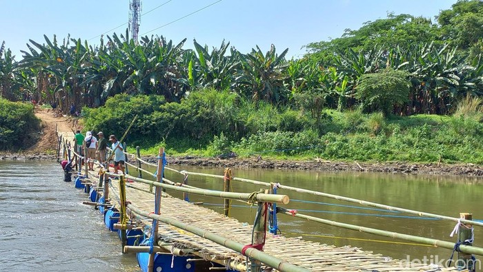 Sejumlah warga tengah membangun jembatan sesek penghubung Desa Gadingan, Kecamatan Mojolaban, Kabupaten Sukoharjo, dengan Kelurahan Sangkrah, Kecamatan Pasar Kliwon, Kota Solo, Kamis (29/9/2022).