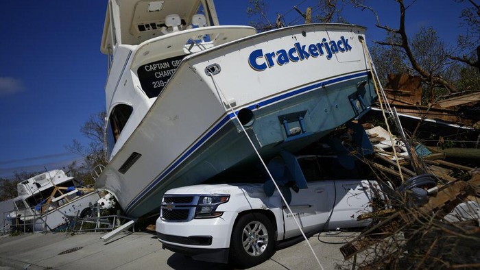 Displaced boats rest lie strewn along the San Carlos Boulevard, one day of the passage of Hurricane Ian, in Fort Myers Beach, Fla., Thursday, Sept. 29, 2022. (AP Photo/Rebecca Blackwell)