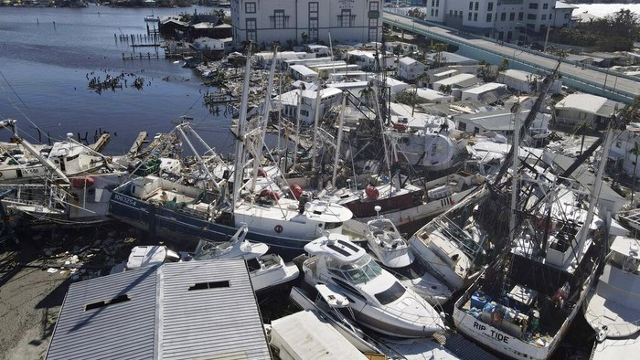 Displaced boats rest lie strewn along the San Carlos Boulevard, one day of the passage of Hurricane Ian, in Fort Myers Beach, Fla., Thursday, Sept. 29, 2022. (AP Photo/Rebecca Blackwell)