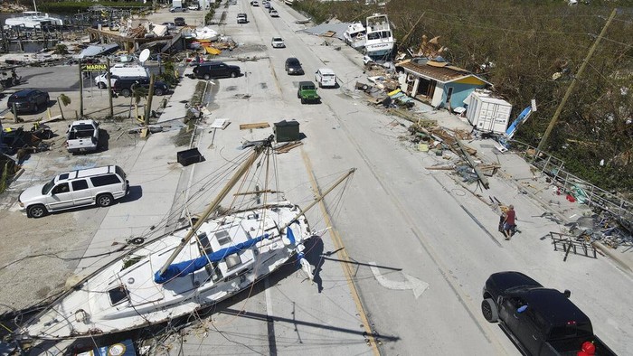 Displaced boats rest lie strewn along the San Carlos Boulevard, one day of the passage of Hurricane Ian, in Fort Myers Beach, Fla., Thursday, Sept. 29, 2022. (AP Photo/Rebecca Blackwell)