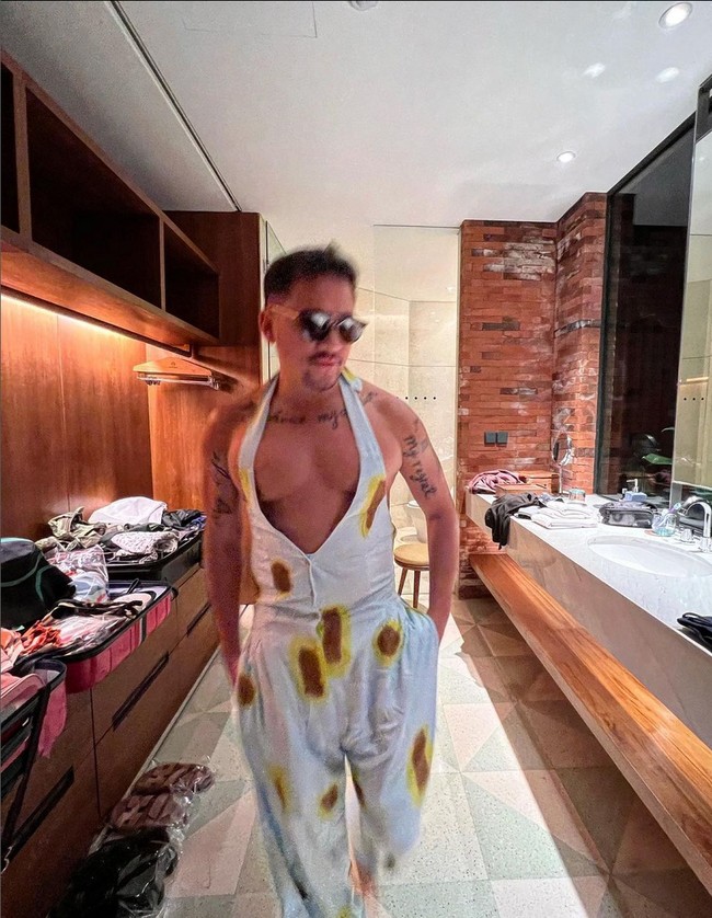 Mario Lawalata berani tampil beda memakai jumpsuit halter dengan belahan dada rendah dan memperlihatkan kulit punggung. Tato di lengan, punggung serta dada pun terekspos. Foto: Instagram/@lawalata13