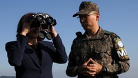 Kamala Harris menggunakan teropong untuk melihat situasi Korea Utara dari zona demiliterisasi di Panmunjom.