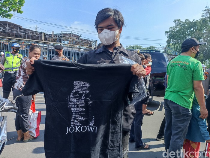 Warga mendapat bingkisan berupa sembako dan kaus dari Jokowi, di kawasan Lubang Buaya, Jakarta Timur, 1 Oktober 2022. (Wildan Noviansah/detikcom)