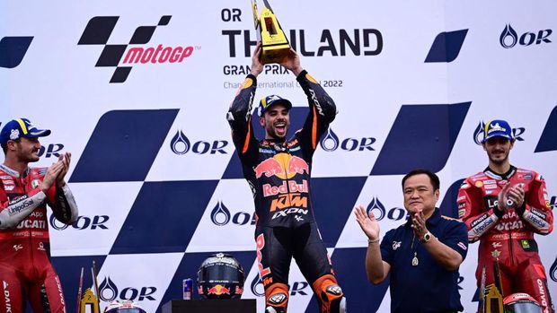 Winner Red Bull KTM Factory Racing's Portuguese rider Miguel Oliveira (C), second-placed Ducati Lenovo's Australian rider Jack Miller (L) and third-placed Ducati Lenovo's Italian rider Francesco Bagnaia (R) celebrate during the podium ceremony after the MotoGP Thailand Grand Prix at the Buriram International Circuit in Buriram on October 2, 2022. (Photo by MANAN VATSYAYANA / AFP) (Photo by MANAN VATSYAYANA/AFP via Getty Images)