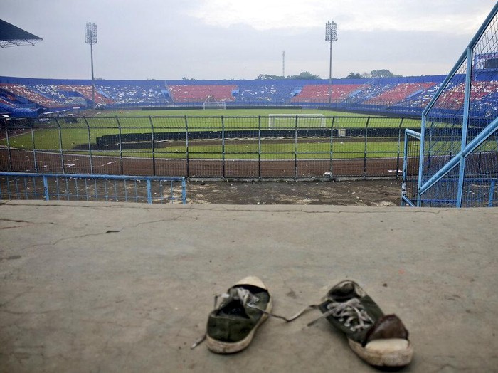 A pair of sneakers sit trampled in the stands of Kanjuruhan Stadium following a deadly soccer match stampede, in Malang, East Java, Indonesia, Sunday, Oct. 2, 2022. Panic at an Indonesian soccer match after police fired tear gas to to disperse supporters invading the pitch left over 100 people dead, mostly trampled to death, police said Sunday. (AP Photo/Hendra Permana)
