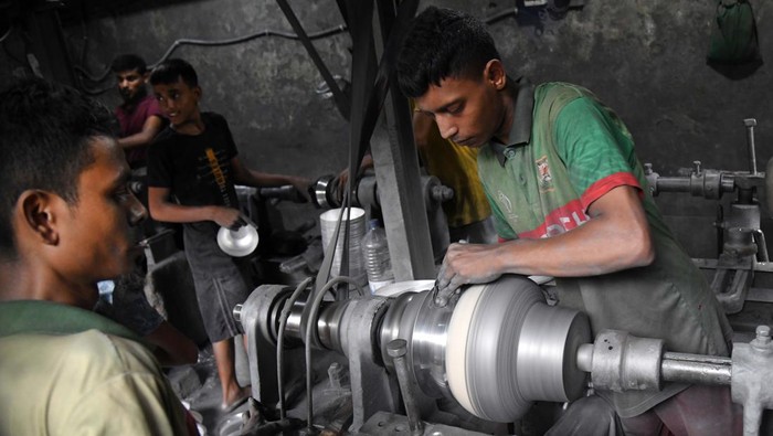 From left Shofiul (13) and Akash (13), during work at a aluminium factory as they earn less than USD 10 in a week in Dhaka, Bangladesh on September 30, 2022. Bangladesh made moderate advancements last year in efforts to eliminate the worst forms of child labour, according to a report of the US Department of Labor published on Wednesday.  (Photo by Syed Mahamudur Rahman/NurPhoto via Getty Images)