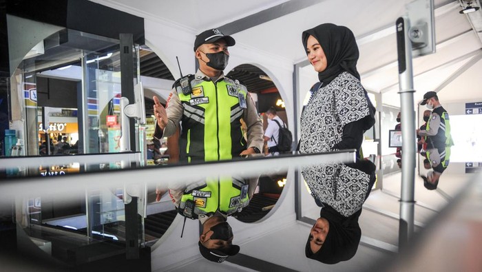 Petugas mengarahkan calon penumpang untuk memindai wajah sebelum memasuki peron Stasiun Bandung, Jawa Barat, Senin (3/10/2022). PT Kereta Api Indonesia (KAI) Persero melakukan uji coba fasilitas 