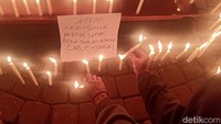 Ratusan suporter sepakbola menggelar aksi doa bersama dan bakar lilin di Alun-alun Banjarnegara. Aksi yang dilakukan oleh berbagai suporter klub sepak bola di Indonesia ini ditujukan untuk korban tragedi Kanjuruhan pada Sabtu (1/10/2022). Foto: Uje Hartono/detikJateng