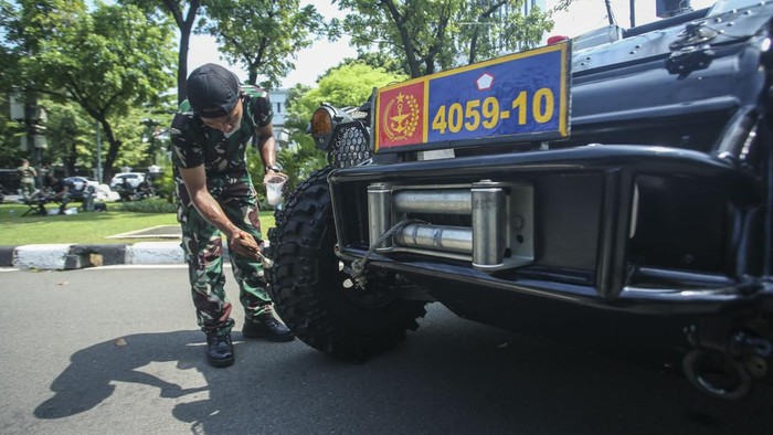 Seorang anggota TNI memeriksa alutsista yang dipajang jelang HUT TNI di Jalan Merdeka Utara, Jakarta, Selasa (4/10/2022).