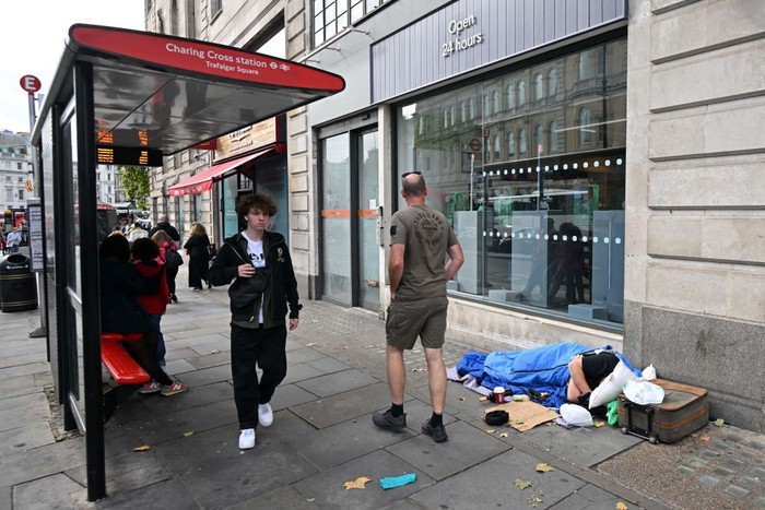 A homeless man sleeps in his sleeping bag on The Strand in central London on October 1, 2022, as campaigners gather in the city to protest against the cost of living crisis. (Photo by JUSTIN TALLIS / AFP) (Photo by JUSTIN TALLIS/AFP via Getty Images)