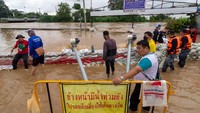 Sejumlah warga dan juga relawan membuat membuat penghalang air selama banjir di Chiang Mai, Thailand, Senin (3/10/2022). Banjir tersebut disebabkan oleh sungai Ping yang meluap.