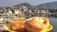 Menikmati pancake khas India yaitu Malpua dengan saus kari ditemani pemadangan danau yang tenang di Pushkar membuat banyak orang jadi ingin mengunjungi India. Foto: Instagram @myyellowplate