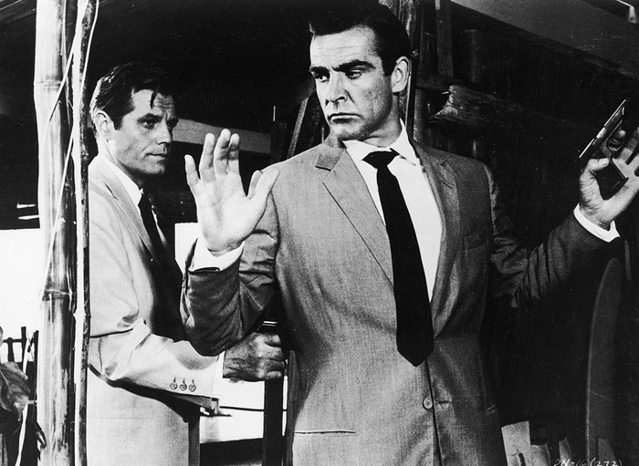 2166387 Jack Lord hold Sean Connery at gunpoint in a still from the James Bond film, 'Dr. No,' directed by Terence Young, 1962. (Photo by United Artists/Courtesy of Getty Images)