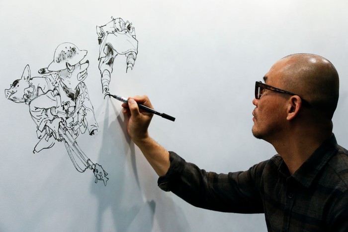 Ilustrator Korea Kim Jung Gi Meninggal Dunia South Korean comic streep writer Kim Jung-gi poses in Paris on March 16, 2016. (Photo by JOEL SAGET / AFP) / BLACK AND WHITE VERSION (Photo credit should read JOEL SAGET/AFP via Getty Images)