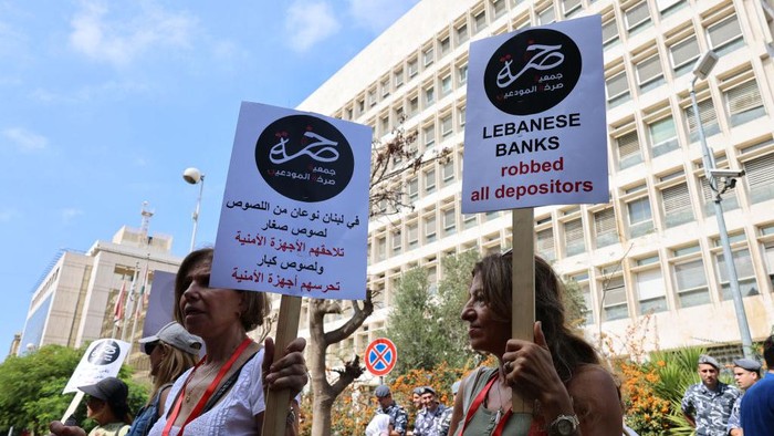 Demonstrators carry banners during a protest organised by 