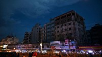 Orang-orang berjalan di sepanjang jalan selama pemadaman listrik di Dhaka. Pemadaman listrik terjadi di sejumlah daerah di barat laut Bangladesh dan beberapa kawasan lain. Namun, masih belum jelas penyebab kerusakan dalam jaringan listrik ini. Kemungkinan penyebabnya adalah kerusakan teknis. Munir Uz Zaman/AFP/Getty Images