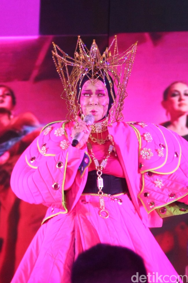 Melly Goeslaw beraksi di panggung dengan gaya uniknya dalam balutan gaun pink dan headpiece heboh.  (Foto: Abduh/Detikcom)