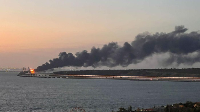 A view shows a fire on the Kerch bridge at sunrise in the Kerch Strait, Crimea, October 8, 2022. REUTERS/Stringer