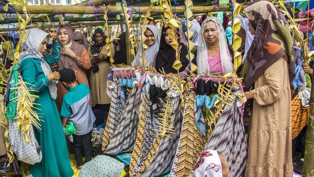 Sejumlah warga mengikuti prosesi tradisi Baayun untuk memperingati Maulid Nabi Muhammad SAW di Halaman Masjid Al Mukaramah Desa Banua Halat Kiri, Kabupaten Tapin, Kalimantan Selatan, Sabtu (8/10/2022). Tradisi Baayun Maulid yang digelar setiap tahunnya oleh Suku Banjar tersebut merupakan kegiatan mengayun bayi, anak-anak, dan dewasa dengan membaca syair maulid yang diikuti sebanyak 4.481 orang untuk memperingati hari kelahiran Nabi Muhammad SAW. ANTARA FOTO/Bayu Pratama S/hp.