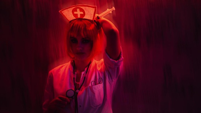 Portrait of a beautiful young woman dressed in a nurse costume for Halloween.