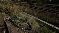 Kabel yang baru dipasang terletak di sebelah rel kereta api di lokasi di distrik Hohenschoenhausen di mana sehari sebelum teknisi memperbaiki bagian kabel serat optik yang terputus dalam tindakan sabotase.