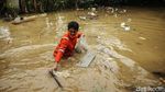 Pasukan Oranye Basah-basahan Bersihkan Sampah di Banjir Rawajati