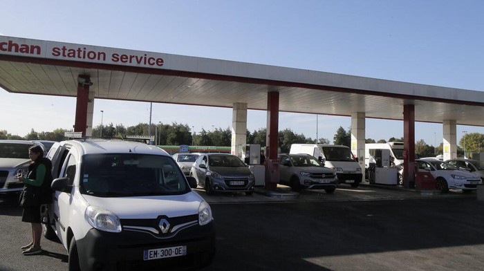Drivers line up as they wait to buy gas in a station, in Lille, northern France, Friday, Oct. 7, 2022. Shortages which the government says are largely caused by strikes that have hit French fuel refineries are making life difficult for drivers in the Paris region and elsewhere. (AP Photo/Michel Spingler)