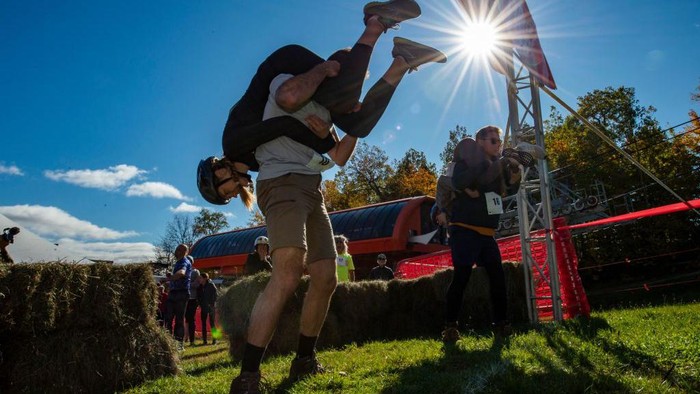 Two teams compete during the 23rd North American Wife Carrying Championship at Sunday River Resort in Newry, Maine, on October 8, 2022. (Photo by Joseph Prezioso / AFP) (Photo by JOSEPH PREZIOSO/AFP via Getty Images)