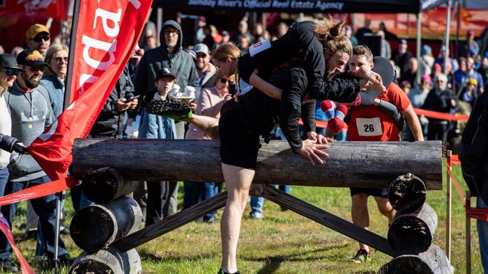 Two teams compete during the 23rd North American Wife Carrying Championship at Sunday River Resort in Newry, Maine, on October 8, 2022. (Photo by Joseph Prezioso / AFP) (Photo by JOSEPH PREZIOSO/AFP via Getty Images)
