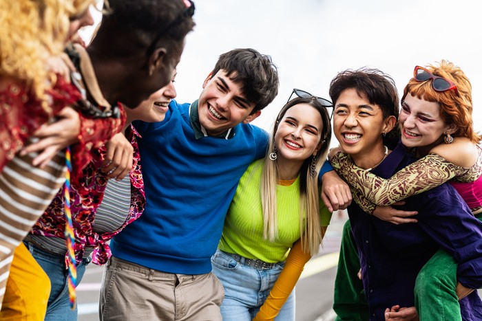 Happy young diverse friends having fun hanging out together - Youth people millennial generation concept