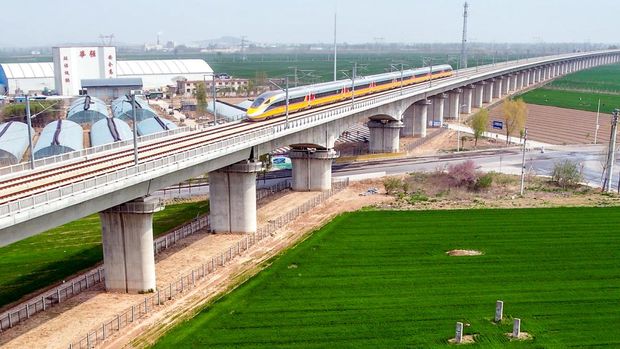 ANYANG, CHINA - APRIL 6, 2022 - Aerial photo show a high-speed railway comprehensive inspection train, which will be exported to Indonesia, passes by on the Jinan-Zhengzhou High-speed Railway in Anyang, Henan Province, China, April 6, 2022. This is the first run of this type of train in China. The Jakarta-Bandung high-speed Railway (JAKarta-Bandung High-Speed Railway) is a high-speed Railway connecting the Greater Jakarta metropolitan area of the Republic of Indonesia with West Java province. It is the first high-speed Railway in Southeast Asia and will be operational in June 2023. The high-speed railway comprehensive inspection train, as an essential and important technical equipment to ensure the safety of high-speed railway line operation, also travels at 350 kilometers per hour. It is used to detect train track condition, measure current and overhead power, test or check communication and signal network and even wheel to track dynamics, etc. It will play a key role in the joint commissioning and trial of jakarta-Bandung high-speed railway and infrastructure maintenance. The Jakarta-Bandung high-speed Railway is a link between China's Belt and Road Initiative and Indonesia's Ocean Fulcrum Strategy. It is a landmark project of practical cooperation between China and Indonesia and also a national strategic project of Indonesia. It connects the capital Jakarta and the fourth largest city Bandung with a length of 142 kilometers and a maximum design speed of 350 kilometers. When completed, the travel time between Jakarta and Bandung will be reduced from more than three hours to 40 minutes. (Photo credit should read Costfoto/Future Publishing via Getty Images)