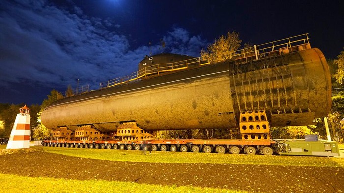 The bow of the Soviet submarine K-3 'Leninsky Komsomol' is transported by a platform along the street from the pier to the museum where it will be assembled with the stern and installed as a museum, in the city of Kronstadt, outside St. Petersburg, Russia, Wednesday, Oct. 12, 2022. K-3 'Leninsky Komsomol' (NATO reporting project name 