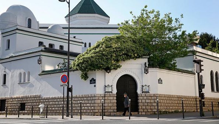 Megahnya Masjid Agung Paris, Cantiknya Luar Biasa PARIS, FRANCE - APRIL 22: A man wearing a protective mask walks past Great Mosque of Paris the day before the start of Ramadan as the lockdown continues due to the coronavirus outbreak (COVID 19) on April 22, 2020 in Paris, France. Muslims around the world celebrate from tomorrow April 23, the holy month of Ramadan. Group gatherings and prayers will not be allowed in mosques as part of government lockdown and containment measures to stop the spread of the coronavirus (Covid-19). The Coronavirus (COVID-19) pandemic has spread to many countries across the world, claiming over 178,000 lives and infecting over 2.5 million people. (Photo by Chesnot/Getty Images)