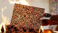 British artist Damien Hirst takes part in a burn event which is part of his latest NFT exhibition 