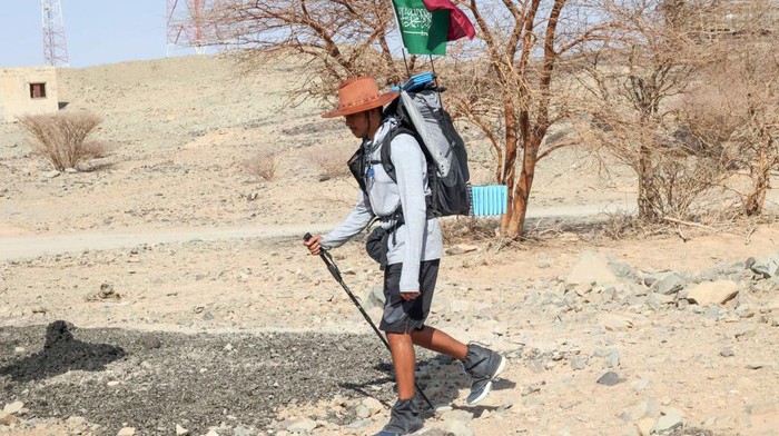 Saudi trekker Abdullah Alsulmi crosses a desert area near al-Khasrah area, some 350Km west of Riyadh, on Septembre 27, 2022, during his solo trek to the Qatari capital ahead of the FIFA World Cup. - The idea hit Alsulmi earlier this year, while he was watching a television show in which a senior Qatari official promised an 