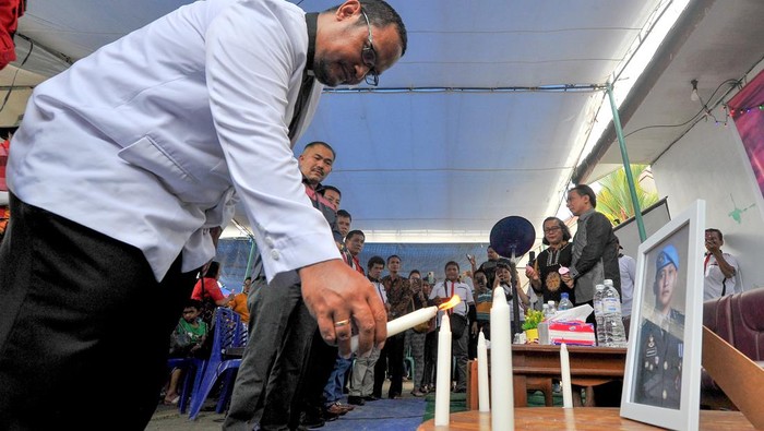 Pemuka agama menyalakan lilin disaksikan keluarga dan kuasa hukum mendiang Brigadir Nofriansyah Yosua Hutabarat atau Brigadir J saat mengenang 100 hari kematian Brigadir J di Sungai Bahar, Muarojambi, Jambi, Sabtu (15/10/2022).Memasuki 100 hari kepergian mediang, pihak keluarga berharap proses persidangan untuk kasus anaknya yang dijadwalkan digelar Senin (17/10/2022) dapat berjalan baik dan seadil-adilnya. ANTARA FOTO/Wahdi Septiawan/rwa.