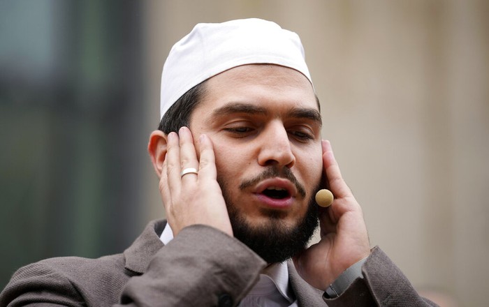 Muezzin Mustafa Kader recites the call to prayer at the Cologne Central Mosque in Cologne, Germany, Friday, Oct. 14, 2022. The Islamic call to prayer is set to sound for the first time from one of Germany’s biggest mosques in Cologne on Friday — but at limited volume. It is part of a project agreed with authorities in the city that has one of the country’s biggest Muslim communities. (AP Photo/Martin Meissner)