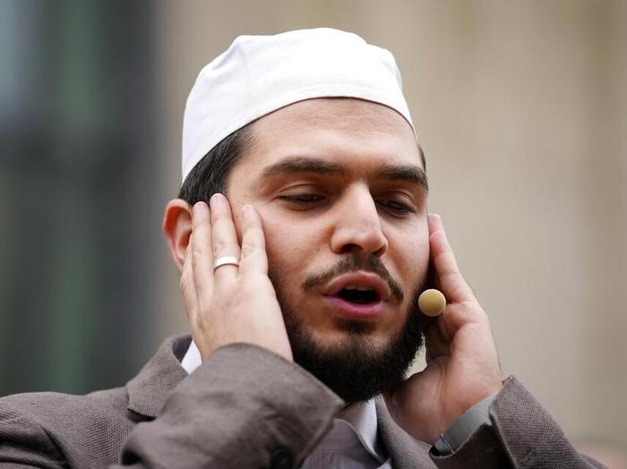 Muezzin Mustafa Kader recites the call to prayer at the Cologne Central Mosque in Cologne, Germany, Friday, Oct. 14, 2022. The Islamic call to prayer is set to sound for the first time from one of Germany’s biggest mosques in Cologne on Friday — but at limited volume. It is part of a project agreed with authorities in the city that has one of the country’s biggest Muslim communities. (AP Photo/Martin Meissner)