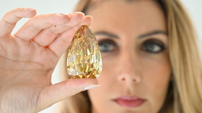 DUBAI, UNITED ARAB EMIRATES - OCTOBER 17: A yellow diamond weighing over 300 carats was unveiled today at Sotheby’s Dubai, pictured with Katia Nounou Boueiz, Head of Sotheby’s UAE on October 17, 2022 in Dubai, United Arab Emirates. The Golden Canary is one of the largest polished diamonds in the world and, at 303.10 Carats, it is the largest flawless or internally flawless diamond ever graded by the Gemological Institute of America (GIA). The diamond will be auctioned at Sotheby’s New York on 7 December, with an estimate in the region of $15 million. It goes on public view in Dubai from today until 19 October, alongside rare luxury items including unique embellished Hermès handbags by Jay Ahr never showcased before in the Middle East, contemporary photographs by Lalla Essaydi and Youssef Nabil and the latest jewelery collection from Gaelle Khouri. (Photo by Cedric Ribeiro/Getty Images for Sotheby's Dubai)