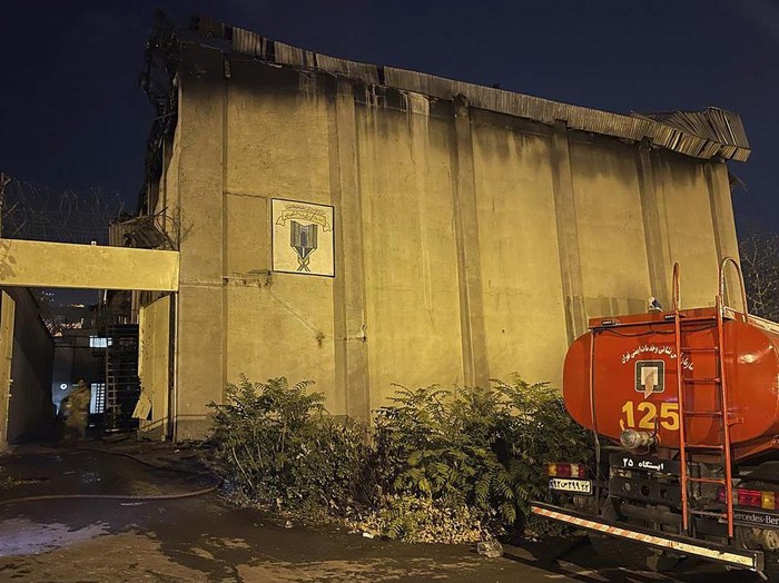 In this photo provided by Islamic Republic News Agency, IRNA, on Sunday, Oct. 16, 2022, a charred building is seen after a fire on the property of the Evin prison, in Tehran, Iran. Flames and smoke rising from the prison had been widely visible Saturday evening, as nationwide anti-government protests triggered by the death of a young woman in police custody entered a fifth week. (IRNA via AP)